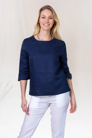 DE TIAMO Tayla Linen Top in French blue — lifestyle outfit shot with white linen pants, timeless everyday styling