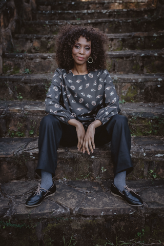 DE TIAMO Cleo Cotton Long Sleeve Top in black — close-up view showing cotton fabric texture and fit