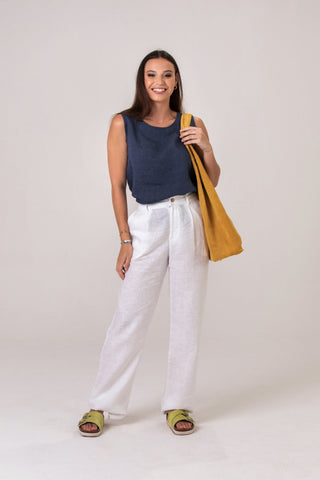 DE TIAMO Georgie Wide-Leg Linen Pants in white — lifestyle shot styled with navy linen top and basket bag