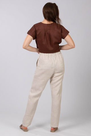 DE TIAMO Paloma Linen Tapered Pants in natural — back view showing patch pocket and elastic drawstring waist